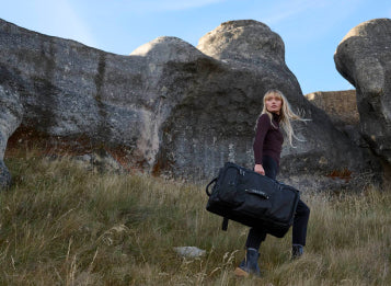 Woman carries Delsey luggage bag from bagdUp Mobile