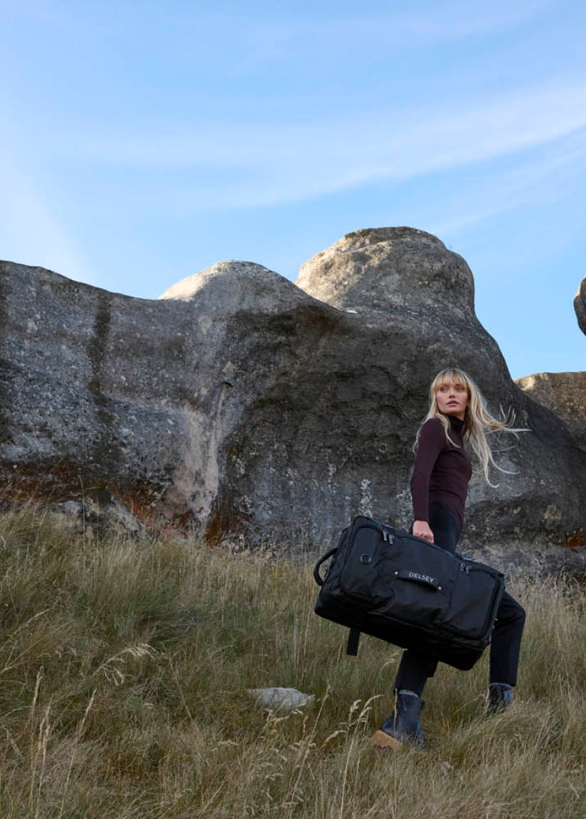 Woman carries Delsey luggage bag from bagdUp